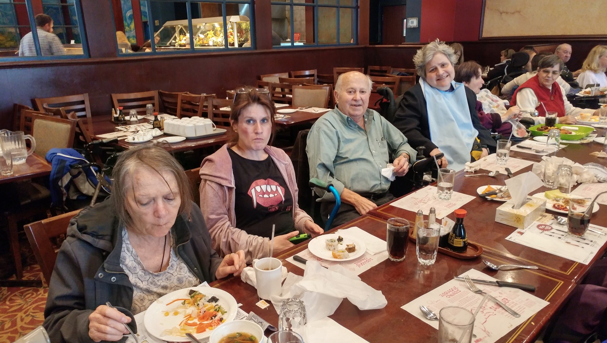 Large group of community members dining together at a shared meal